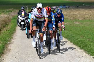 WEVELGEM BELGIUM MARCH 24 LR Mathieu van der Poel of The Netherlands and Team Alpecin Deceuninck Mads Pedersen of Denmark and Team Lidl Trek and Laurence Pithie of New Zealand and Team Groupama FDJ compete in the breakaway passing through the Plugstreets during the 86th GentWevelgem in Flanders Fields 2024 Mens Elite a 2531km one day race from Ieper to Wevelgem UCIWT on March 24 2024 in Wevelgem Belgium Photo by Tim de WaeleGetty Images